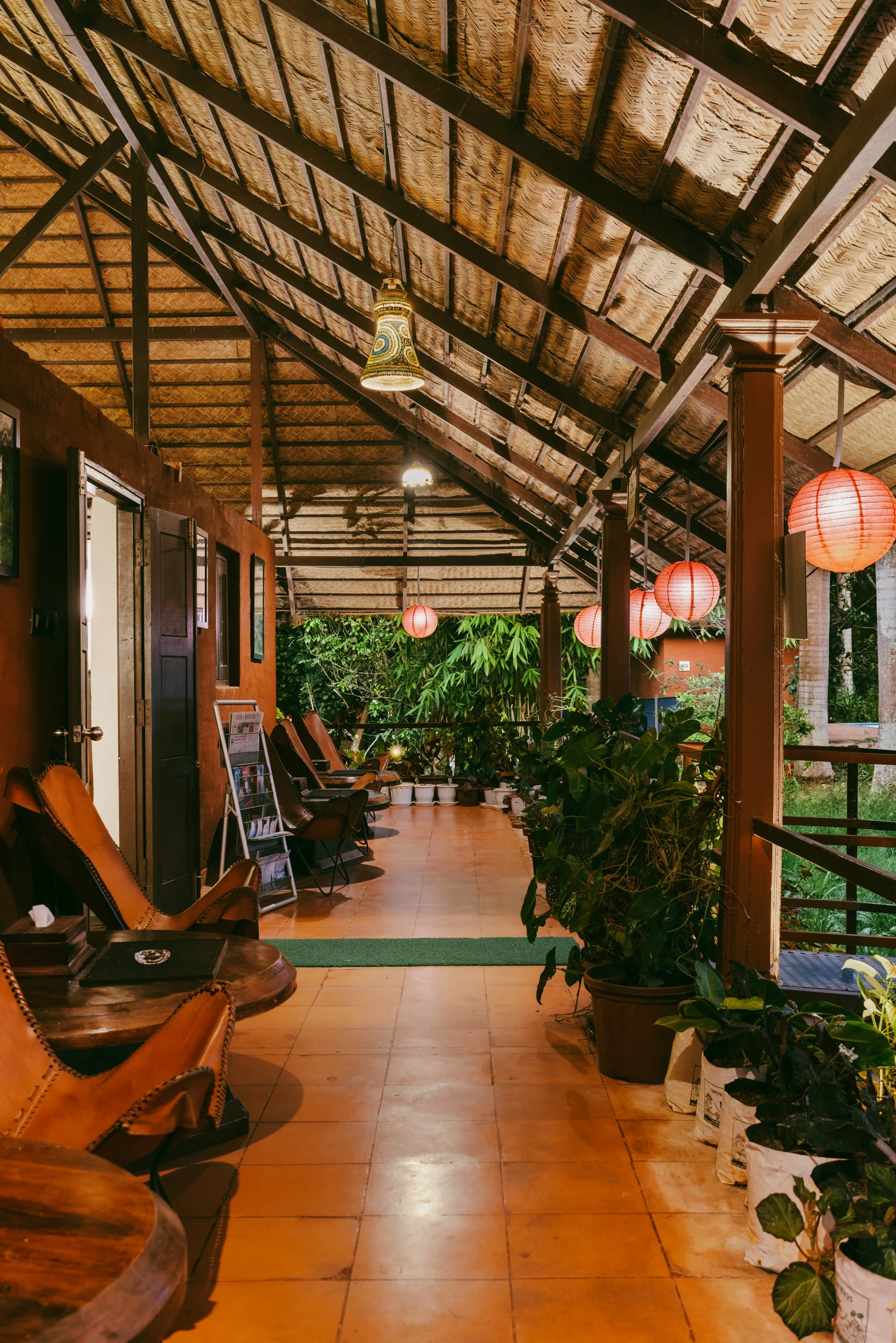 A shaded cottage verandah lit by red lanterns