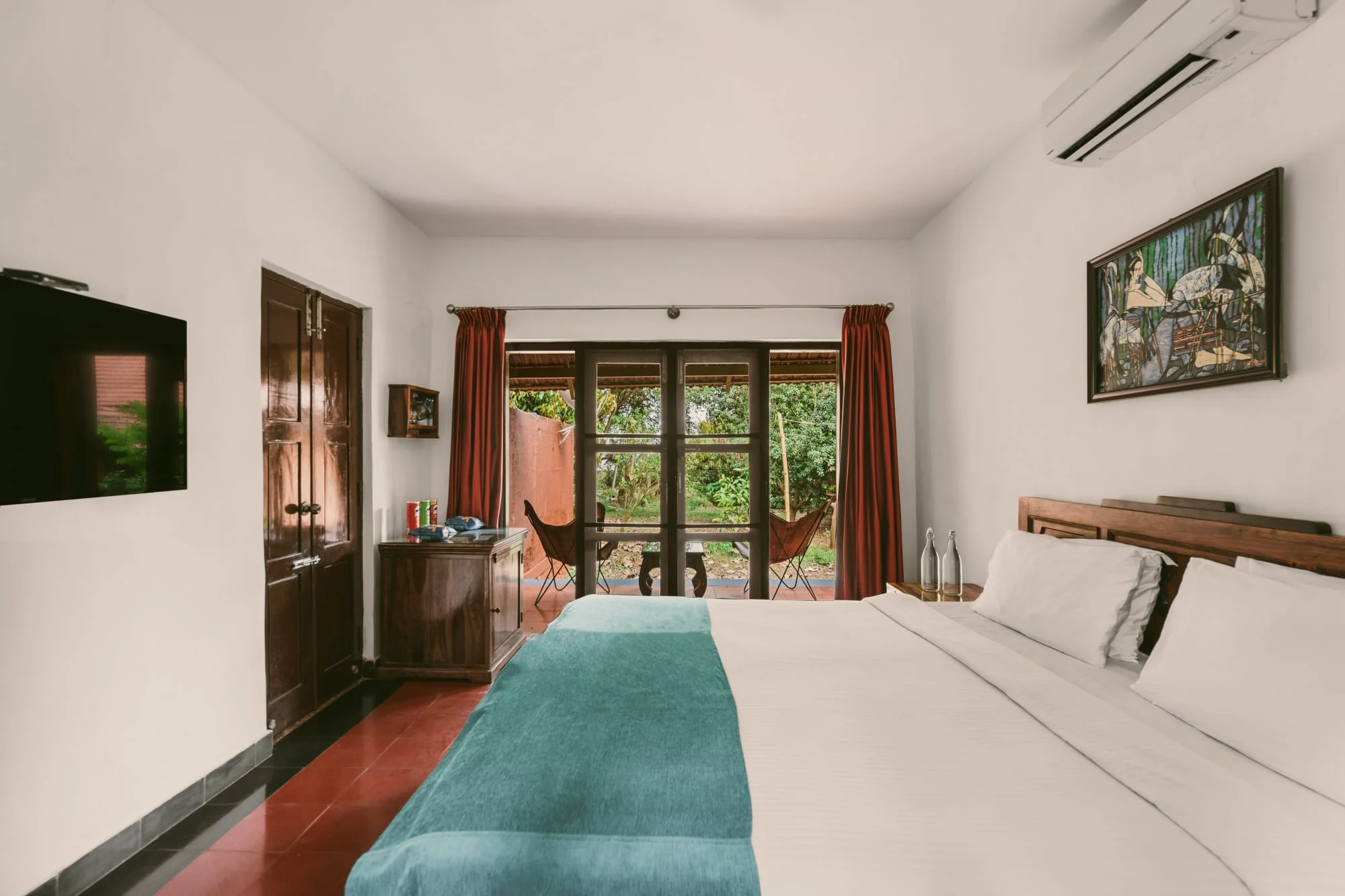 A bright Kabini bedroom opening onto its private garden