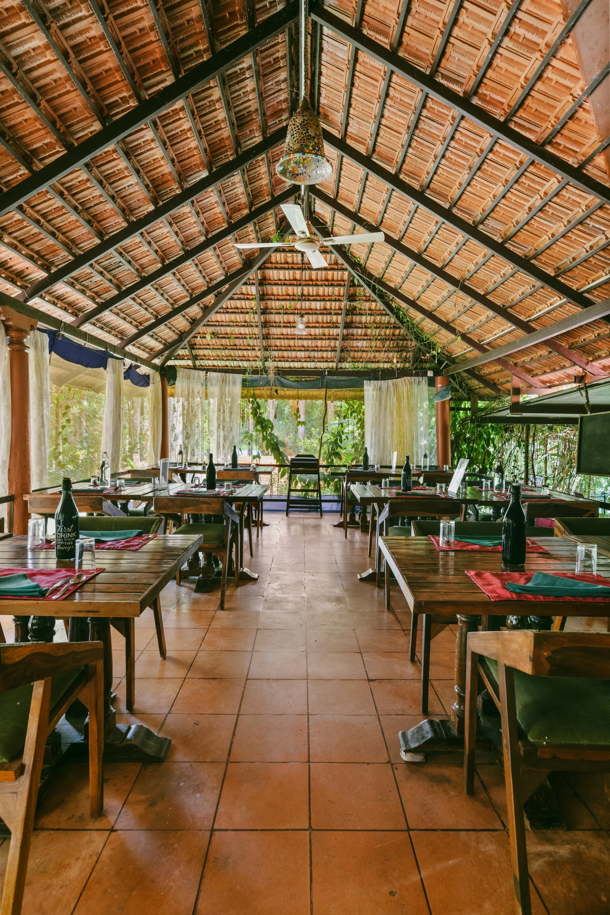The open-sided dining pavilion beneath its thatched roof