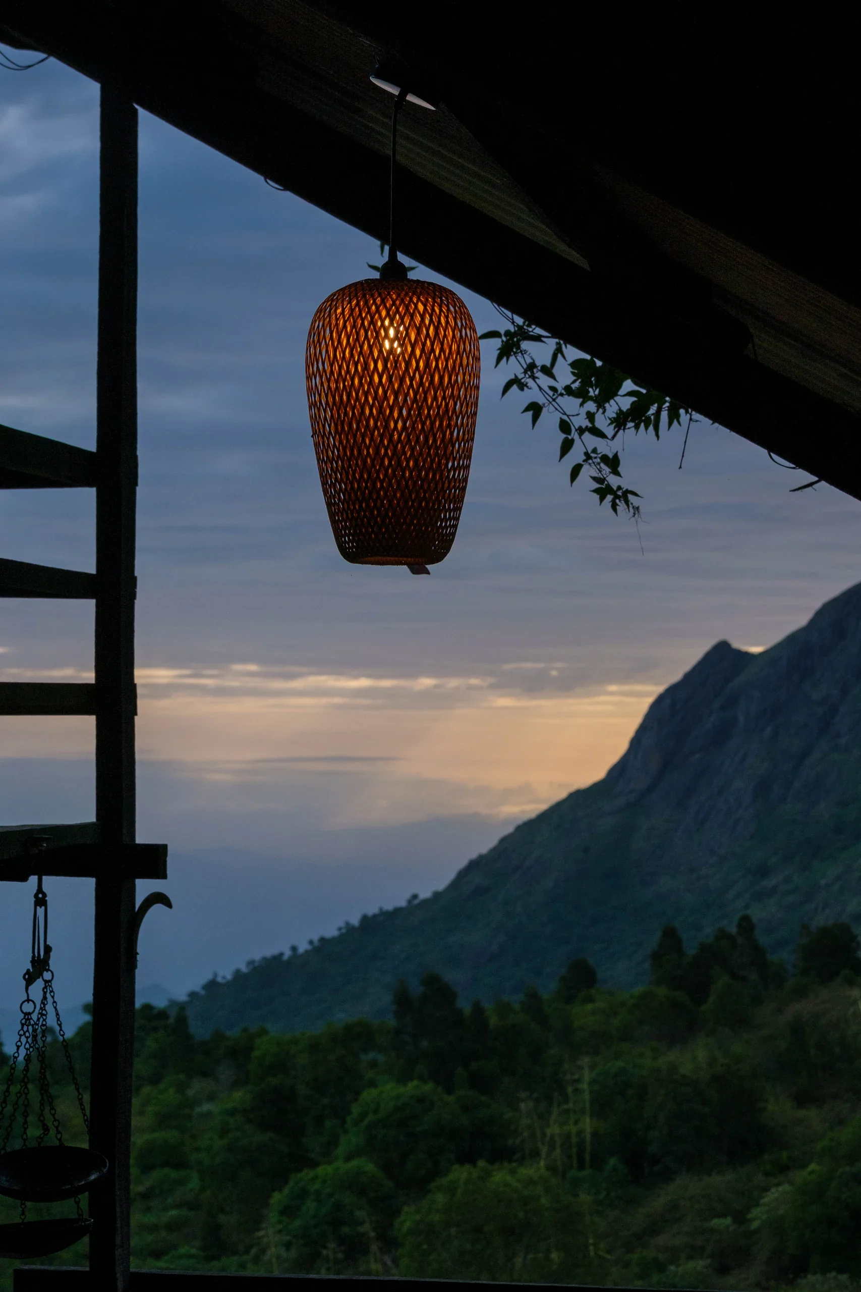 A woven lantern on the verandah overlooking the Nilgiri mountains at dusk