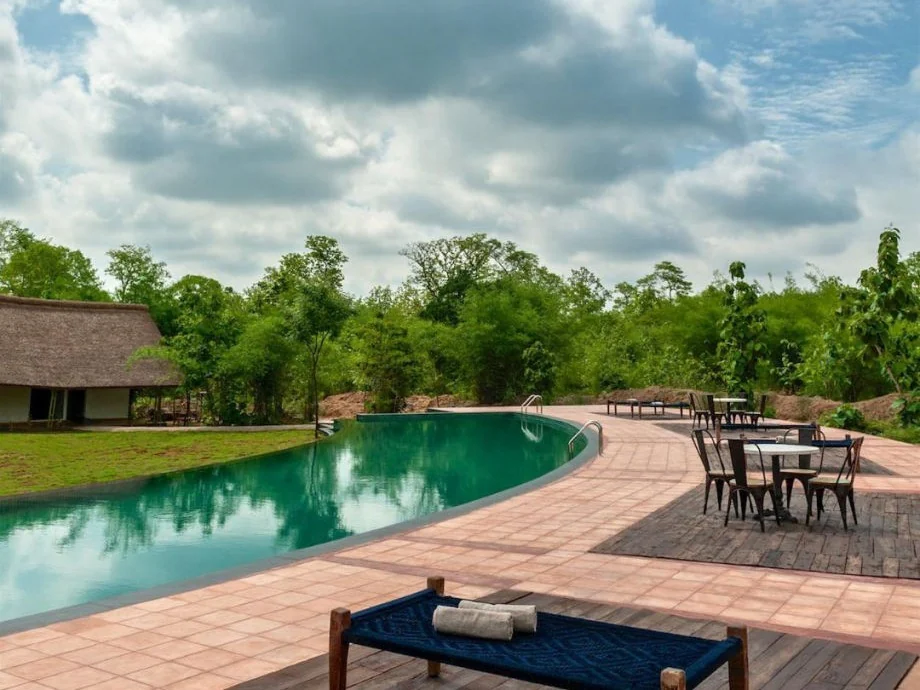 The retreat pool reflecting forest and monsoon clouds