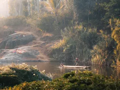 A guest fishing beside a calm stream in the hills