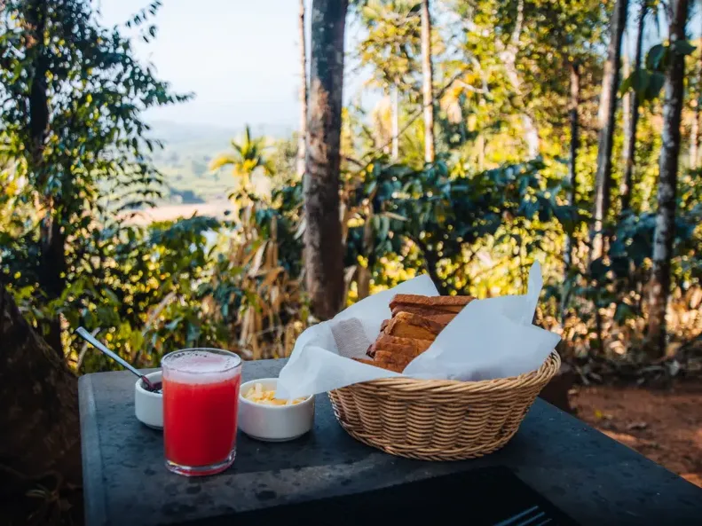 A fresh breakfast basket and juice served outdoors